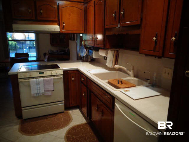 2804 Pine Ridge Drive Lillian, AL 36549 - Photo 12 of 39 11 x 09. Italian porcelain tiled floor. Ceiling fan/light. Recessed lights plus solar light tube. Almond Maytag flat top electric range with vented hood/light. Almond Kenmore extra quiet dishwasher