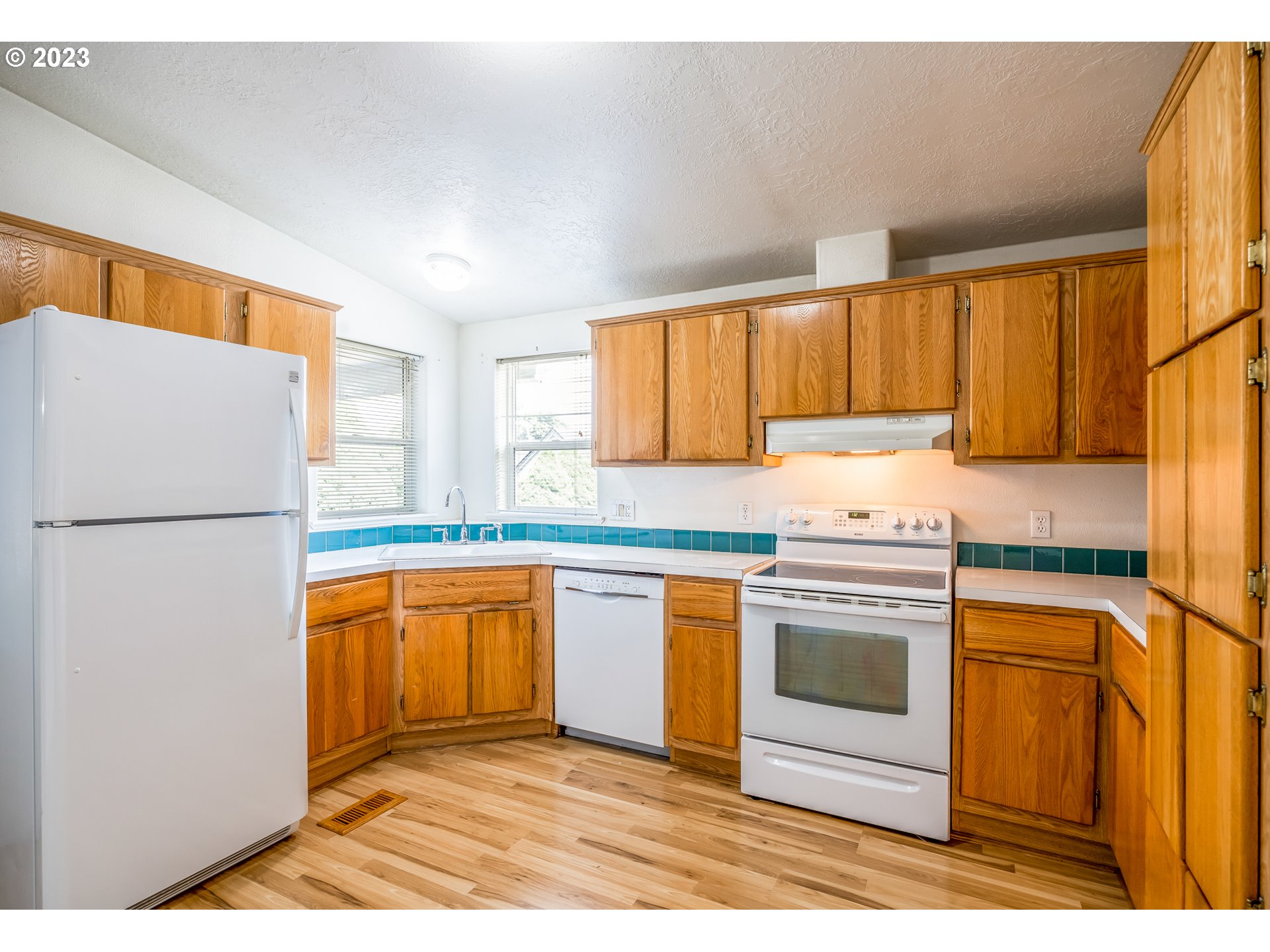230 19th Street Springfield, OR 97477 - Photo 12 of 34 a kitchen with stainless steel appliances granite countertop a refrigerator sink and stove
