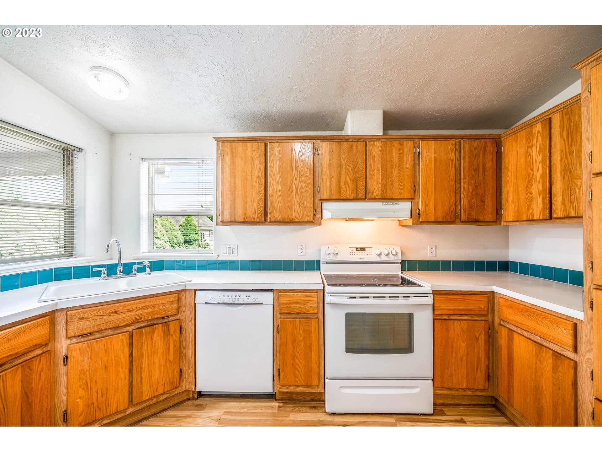 230 19th Street Springfield, OR 97477 - Photo 15 of 34 a kitchen with stainless steel appliances granite countertop a stove a sink and a microwave