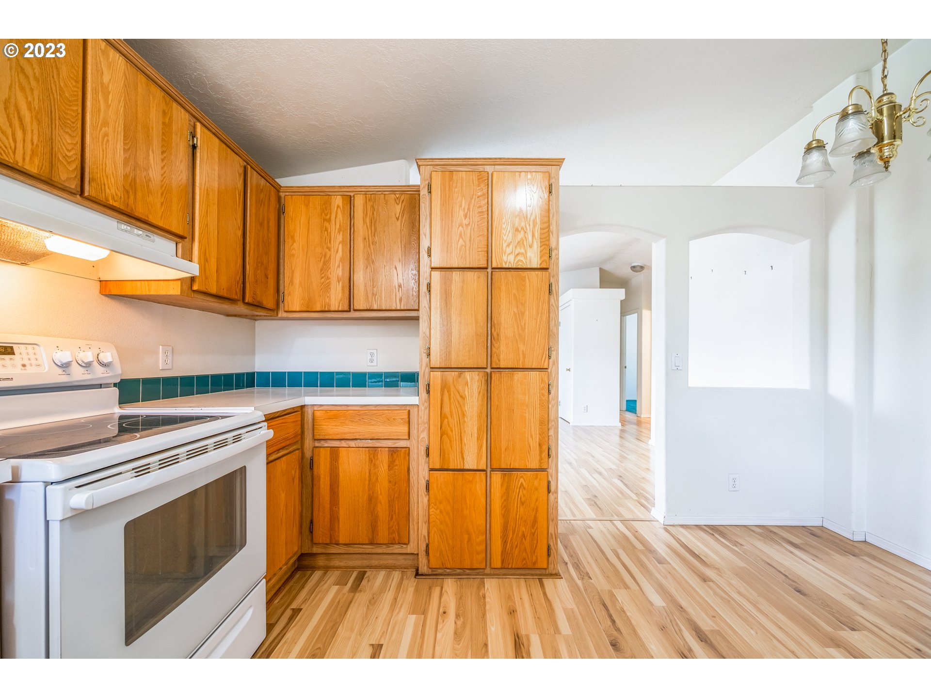 230 19th Street Springfield, OR 97477 - Photo 17 of 34 a kitchen with stainless steel appliances granite countertop a refrigerator a stove and a wooden cabinets