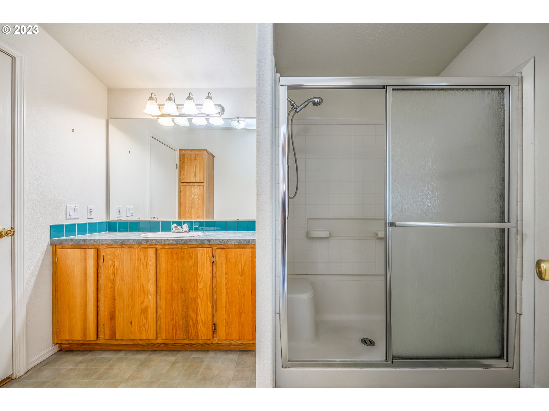 230 19th Street Springfield, OR 97477 - Photo 20 of 34 a bathroom with a mirror and a shower