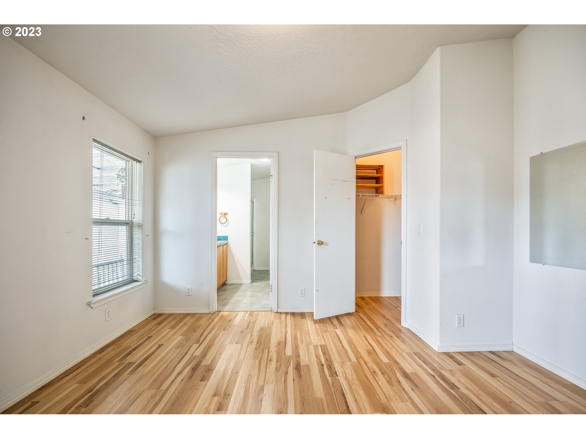230 19th Street Springfield, OR 97477 - Photo 23 of 34 a view of an empty room with wooden floor and windows