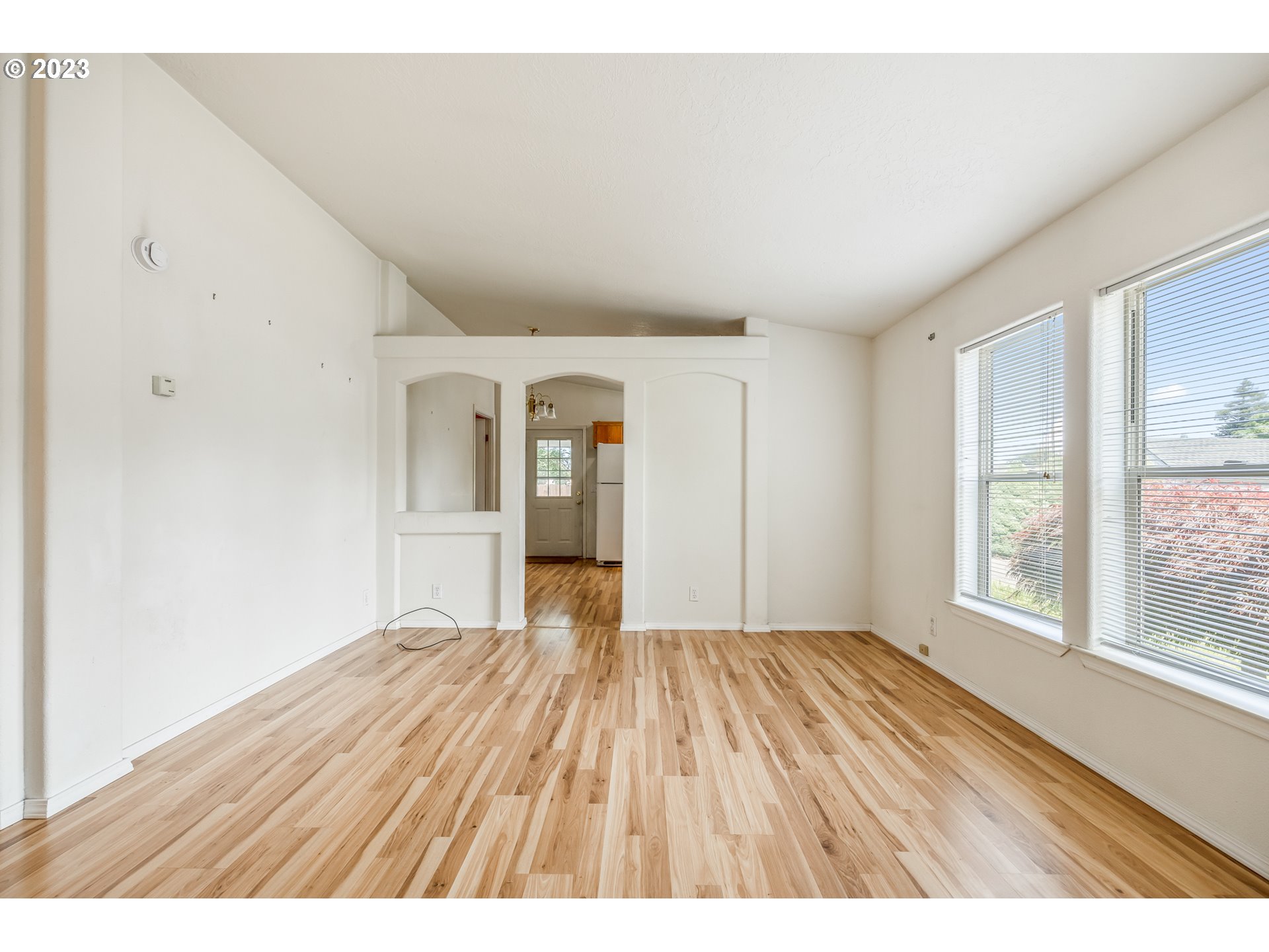 230 19th Street Springfield, OR 97477 - Photo 26 of 34 a view of an empty room with a window and wooden floor