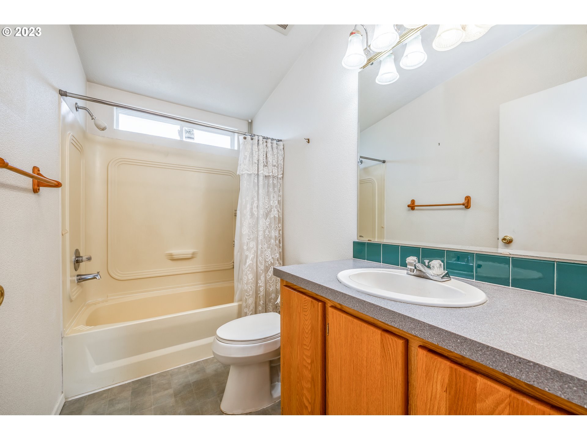 230 19th Street Springfield, OR 97477 - Photo 30 of 34 a bathroom with a granite countertop sink toilet a mirror a bathtub and shower