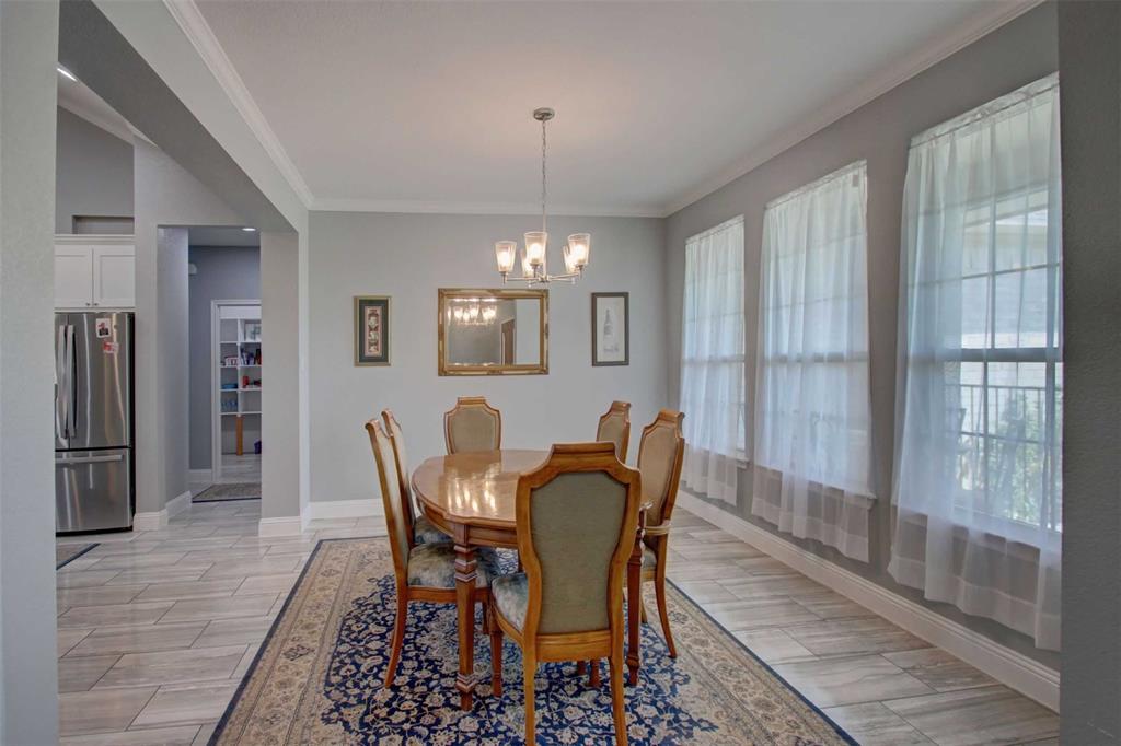 8789 Hutcheson Hill Road Springtown, TX 76082 - Photo 11 of 32 a view of a dining room with furniture and a chandelier