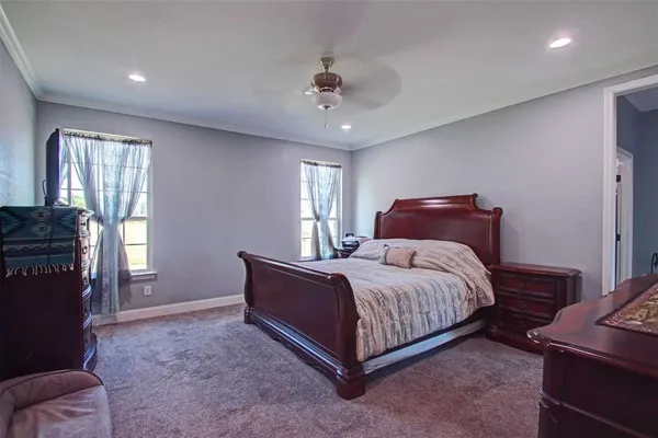 a bedroom with a bed and a chandelier