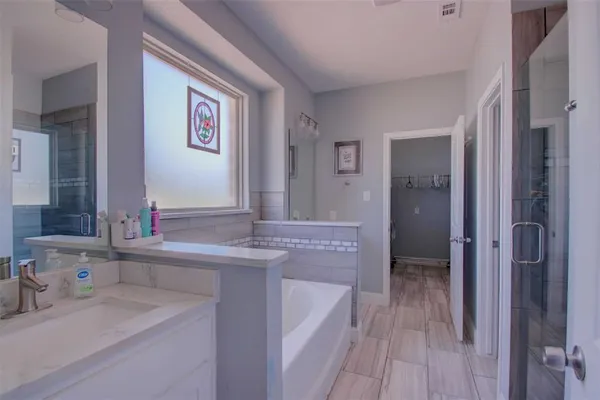a bathroom with a bathtub and a shower