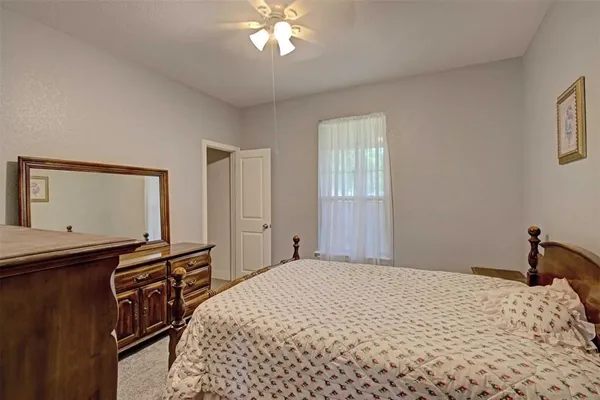 a bedroom with bed and a chandelier
