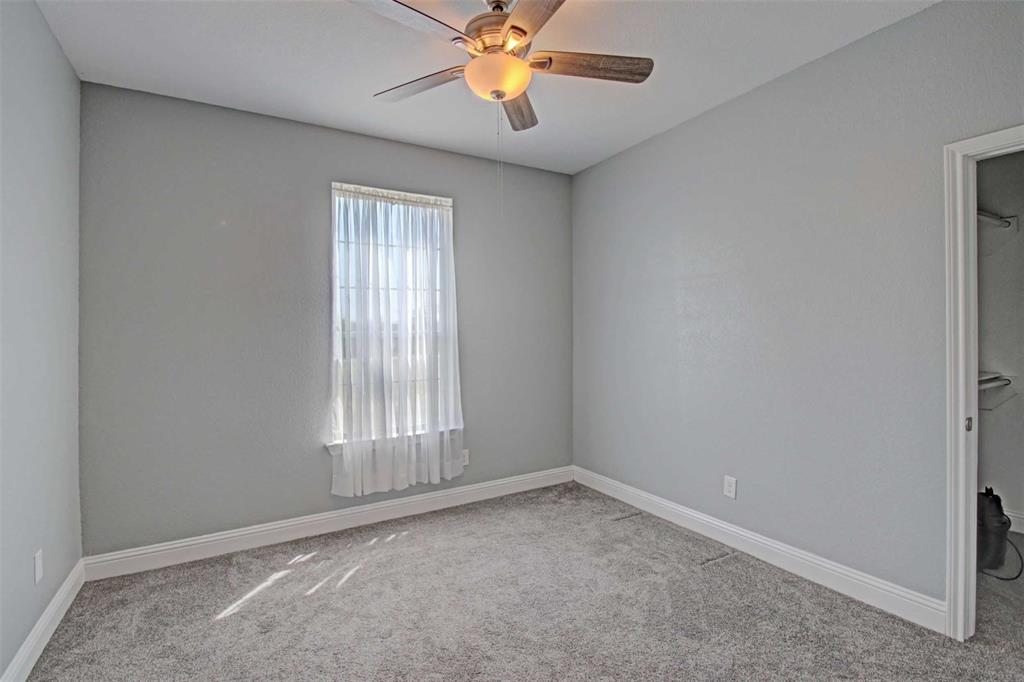 8789 Hutcheson Hill Road Springtown, TX 76082 - Photo 23 of 32 a view of an empty room with window and chandelier fan