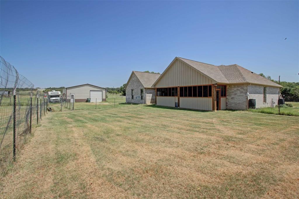 8789 Hutcheson Hill Road Springtown, TX 76082 - Photo 27 of 32 a house with a yard