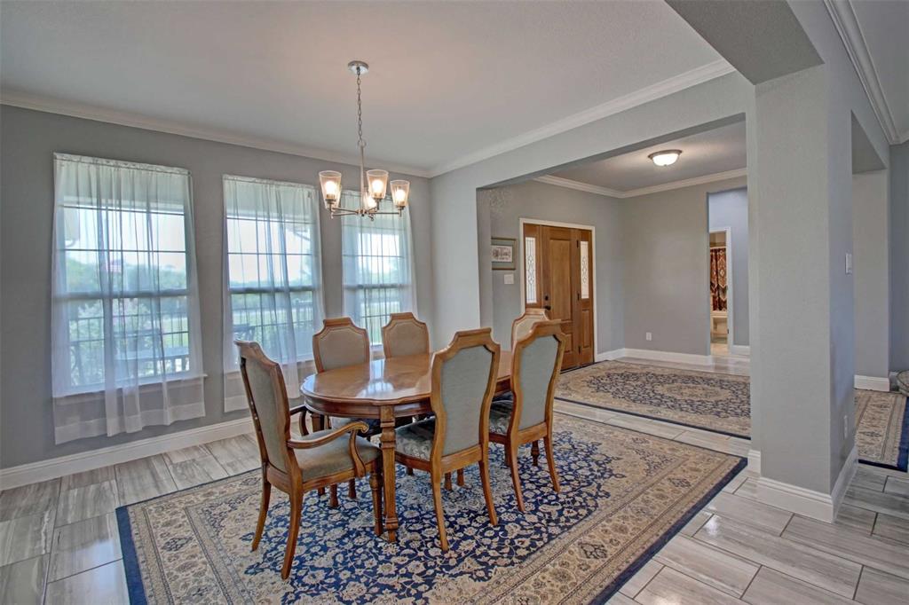 8789 Hutcheson Hill Road Springtown, TX 76082 - Photo 10 of 32 a view of a dining room with furniture window and wooden floor