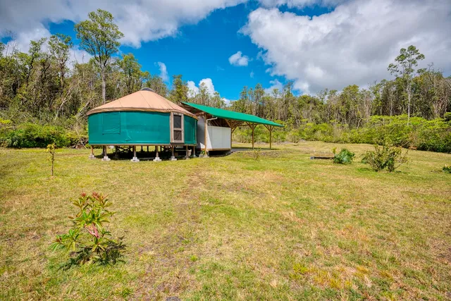 a blue swimming pool is in front of the house