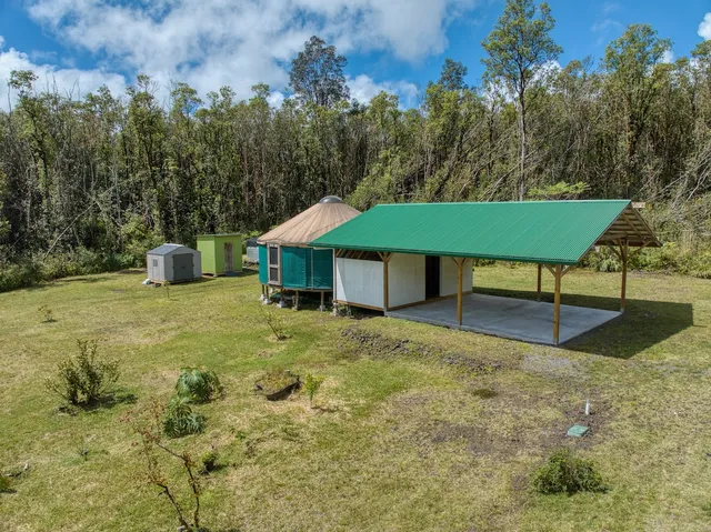a view of a house with backyard porch and sitting area