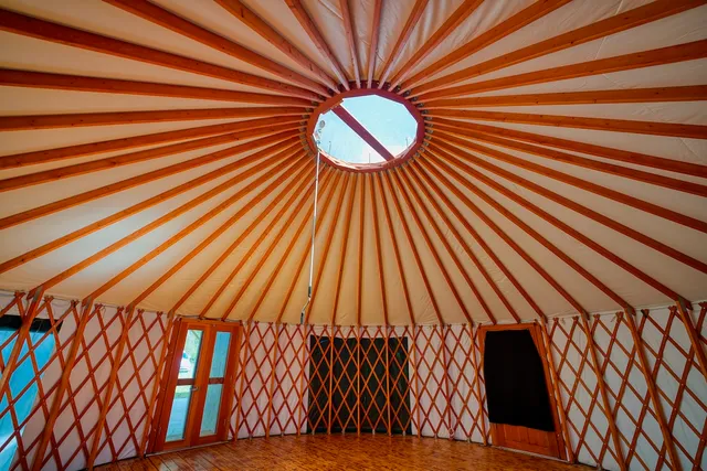 a view of a room with wooden floor and large windows