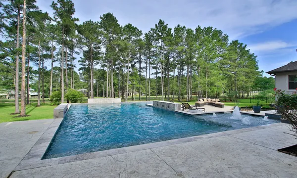 a view of a patio with couches and a table and chairs with wooden fence