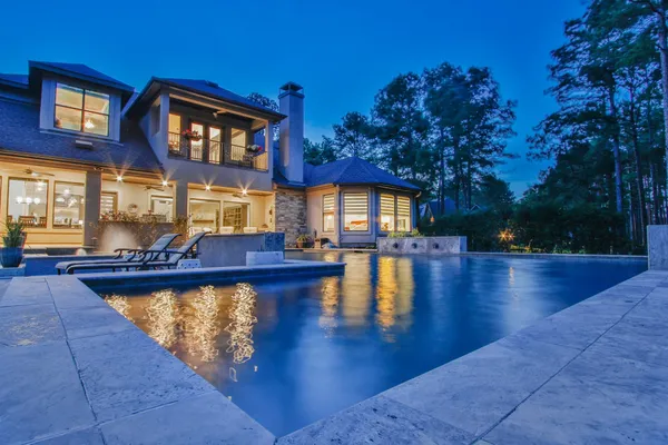 a view of a patio with couches table and chairs and potted plants