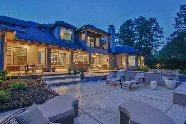 a view of a house with a backyard and a tree