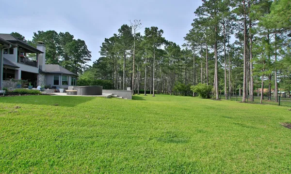 a bathroom with a granite countertop sink a toilet and a mirror