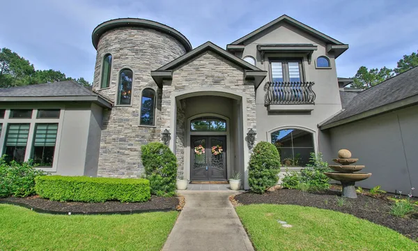 a front view of a house with garden