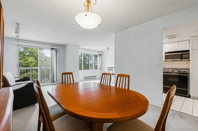 a kitchen with granite countertop cabinets stainless steel appliances and a sink