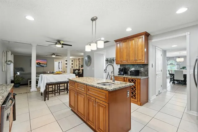 a kitchen with stainless steel appliances granite countertop a sink a stove and cabinets