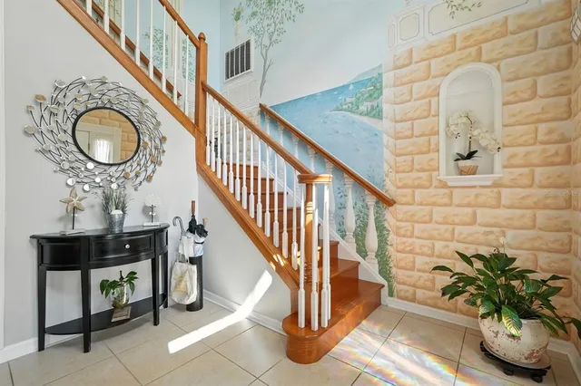 a living room with furniture and a book shelf