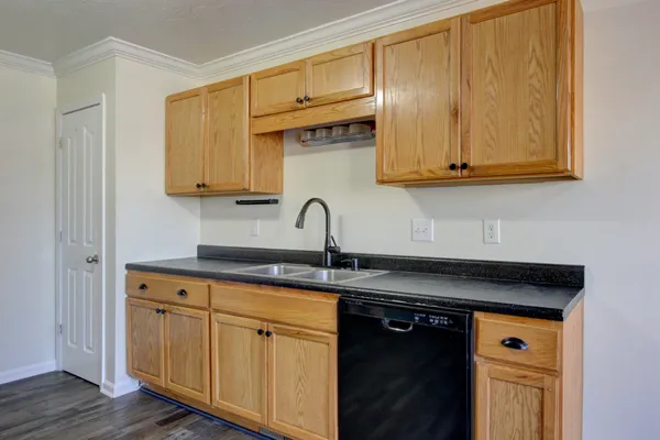 a kitchen with granite countertop a sink and cabinets