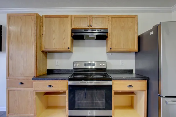a kitchen with stainless steel appliances granite countertop a stove and a microwave