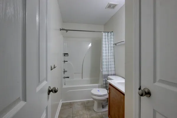 a bathroom with a toilet and shower