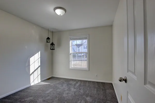 an empty room with windows and closet