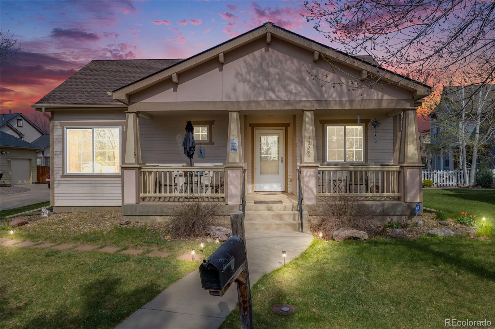 1328 Carriage Drive Longmont, CO 80501 - Photo 1 of 31 front view of a house with a yard