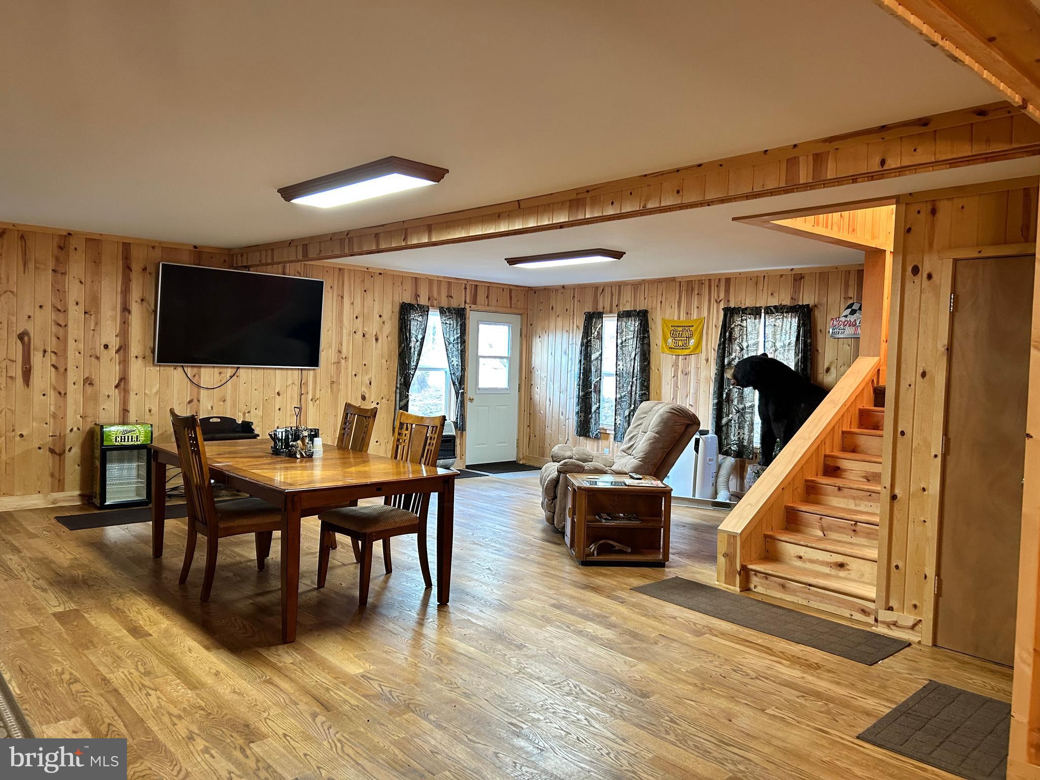 385 Elk Creek Road Aaronsburg, PA 16820 - Photo 21 of 89 a living room with furniture a rug and a flat screen tv