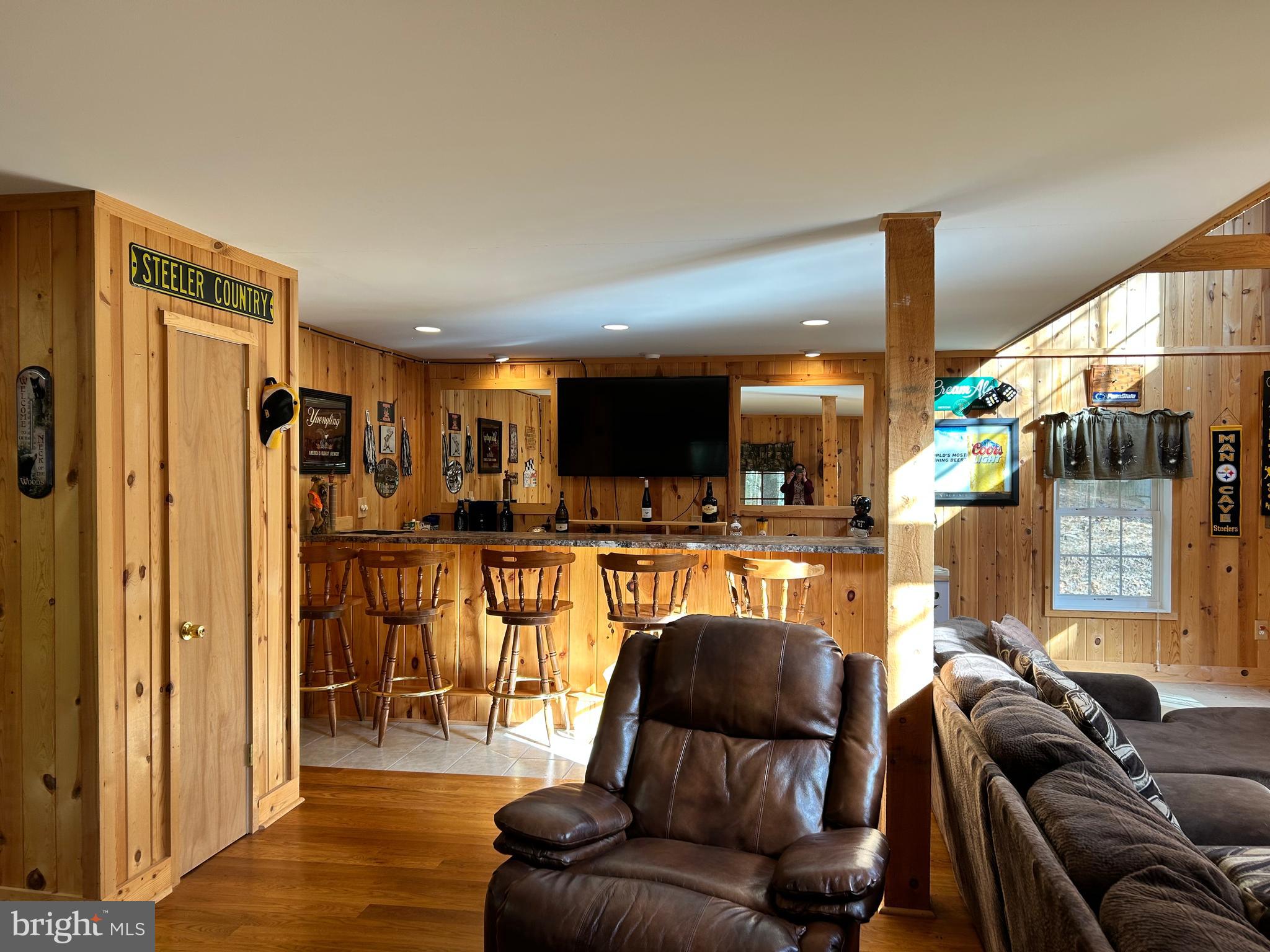 385 Elk Creek Road Aaronsburg, PA 16820 - Photo 23 of 89 a living room with furniture and a flat screen tv