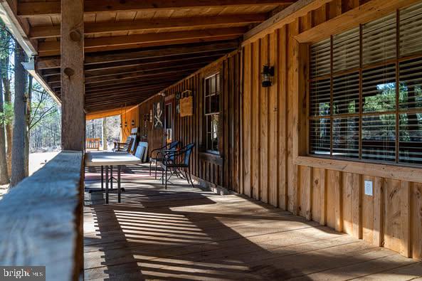 385 Elk Creek Road Aaronsburg, PA 16820 - Photo 31 of 89 a view of a patio with a table and chairs and wooden floor