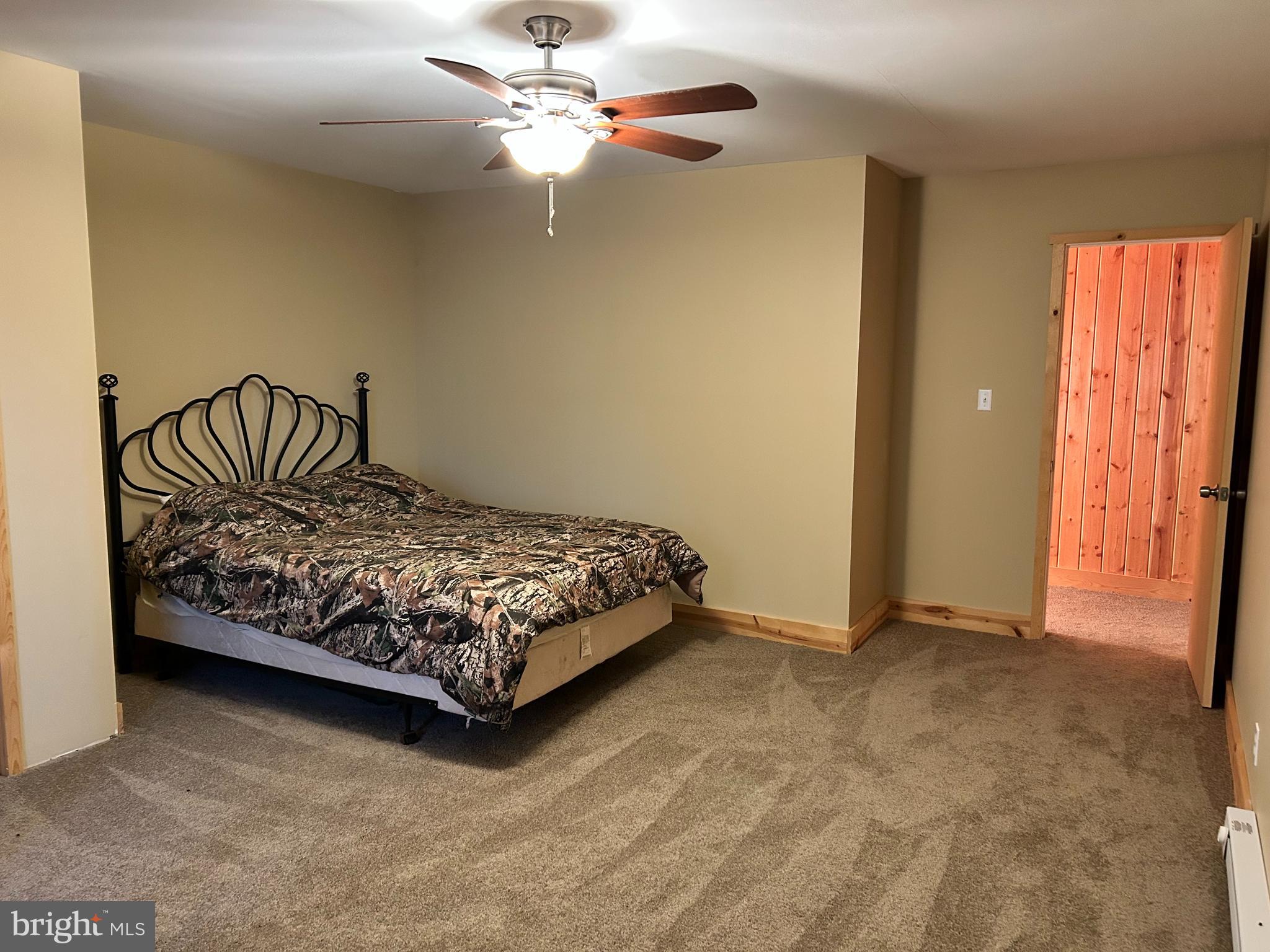 385 Elk Creek Road Aaronsburg, PA 16820 - Photo 38 of 89 a bedroom with a bed and a chandelier