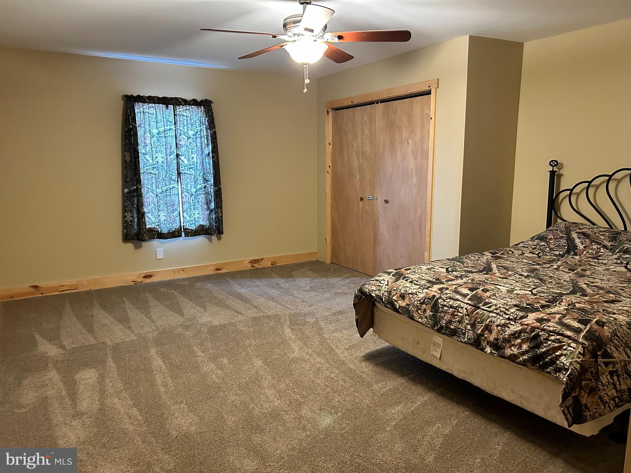 385 Elk Creek Road Aaronsburg, PA 16820 - Photo 39 of 89 a bedroom with a bed and a chandelier