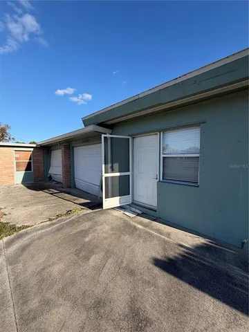 a view of a balcony with chairs and wooden fence