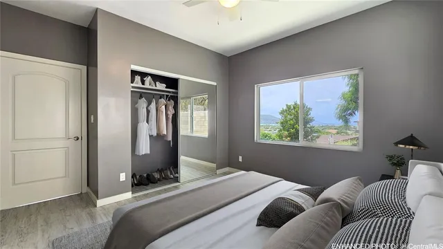 a bedroom with a bed and a painting on the wall