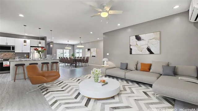 a living room with furniture and kitchen view