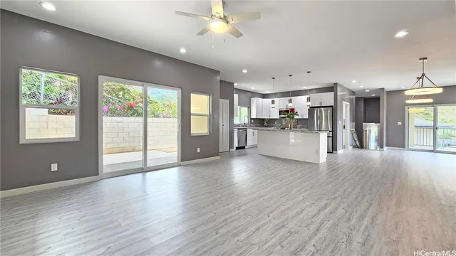 a view of a kitchen with wooden floor and a window