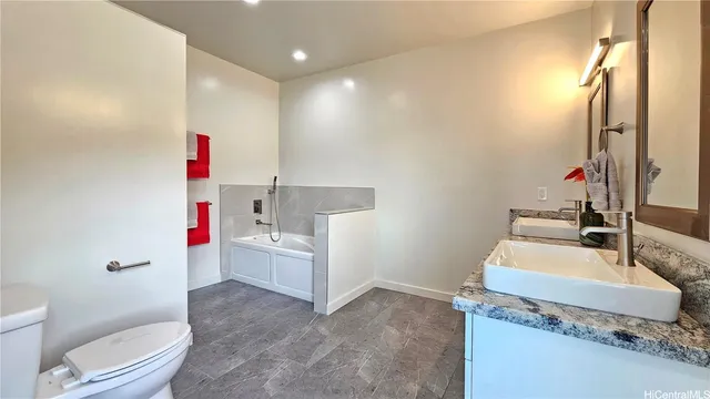 a bathroom with a sink vanity mirror and toilet