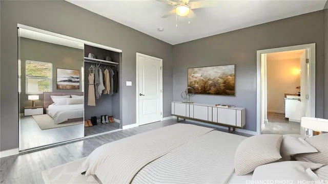 a spacious bedroom with a bed and a flat screen television