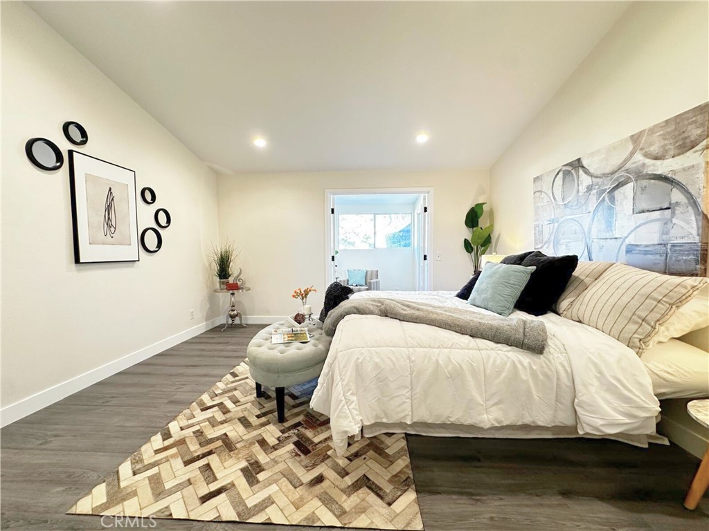 54838 El Prado Trail, Unit C7 Yucca Valley, CA 92284 - Photo 18 of 18 a bedroom with a bed and wooden floor