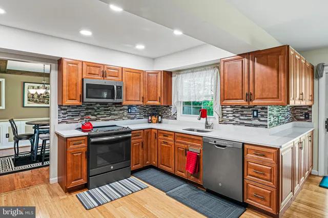 a kitchen with stainless steel appliances granite countertop a stove and cabinets