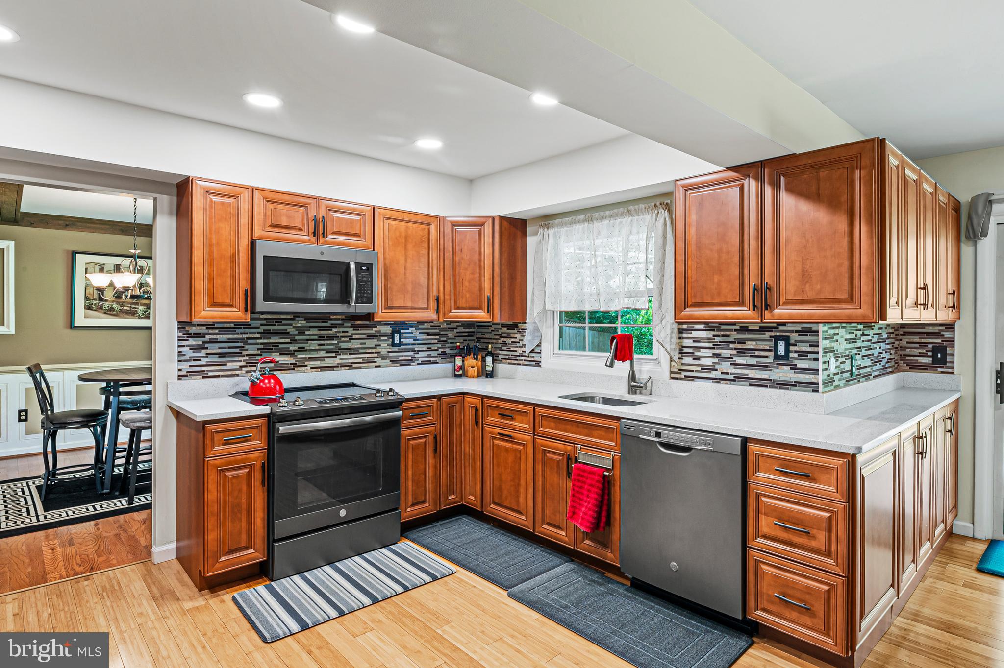 12128 Long Ridge Lane Bowie, MD 20715 - Photo 12 of 39 a kitchen with stainless steel appliances granite countertop a stove and cabinets