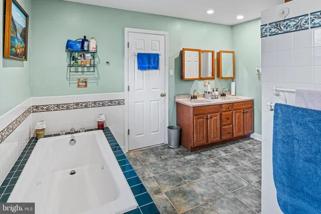 a view of kitchen with stainless steel appliances cabinets and wooden floor