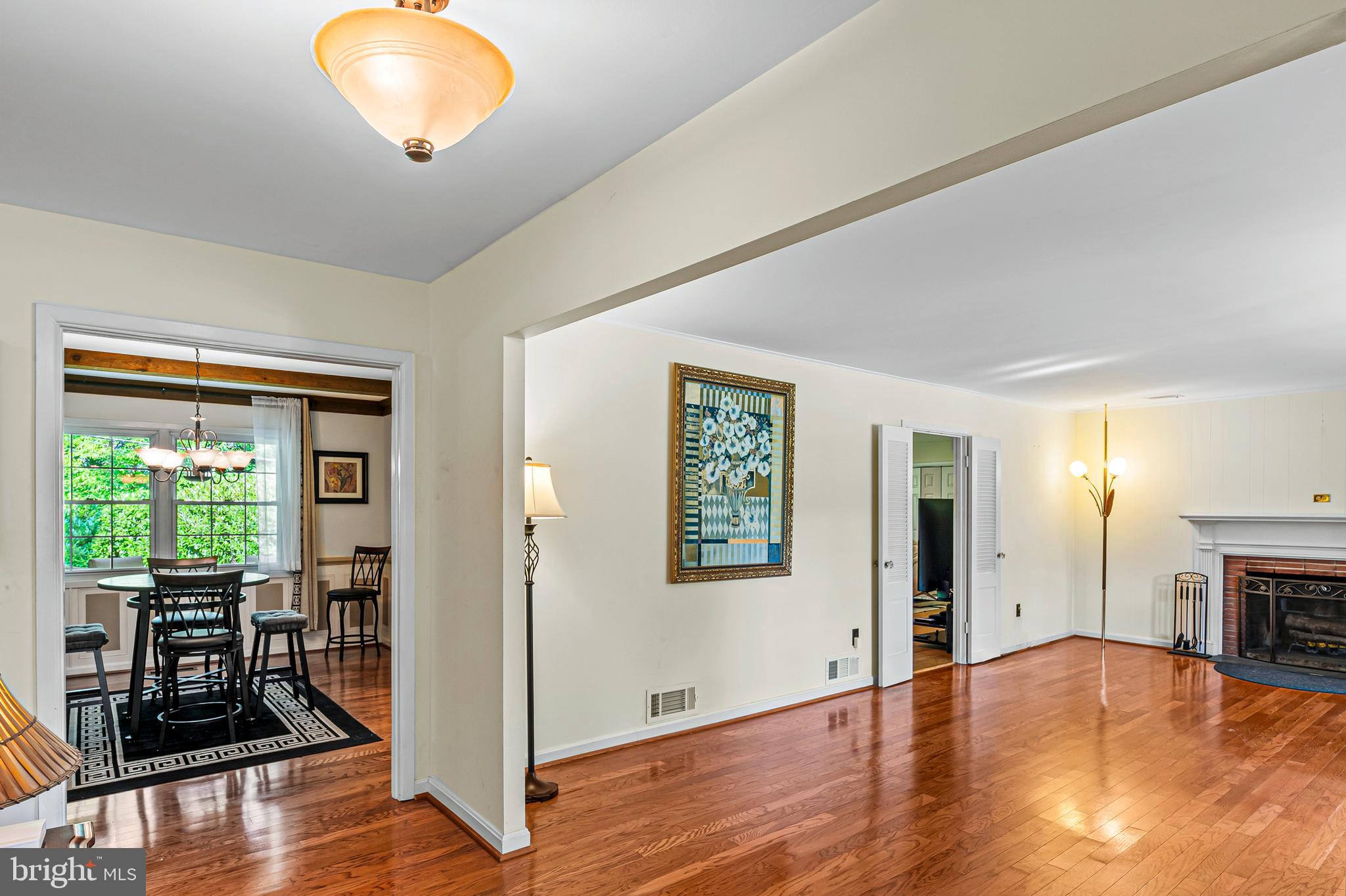 12128 Long Ridge Lane Bowie, MD 20715 - Photo 6 of 39 an empty room with wooden floor fireplace and windows