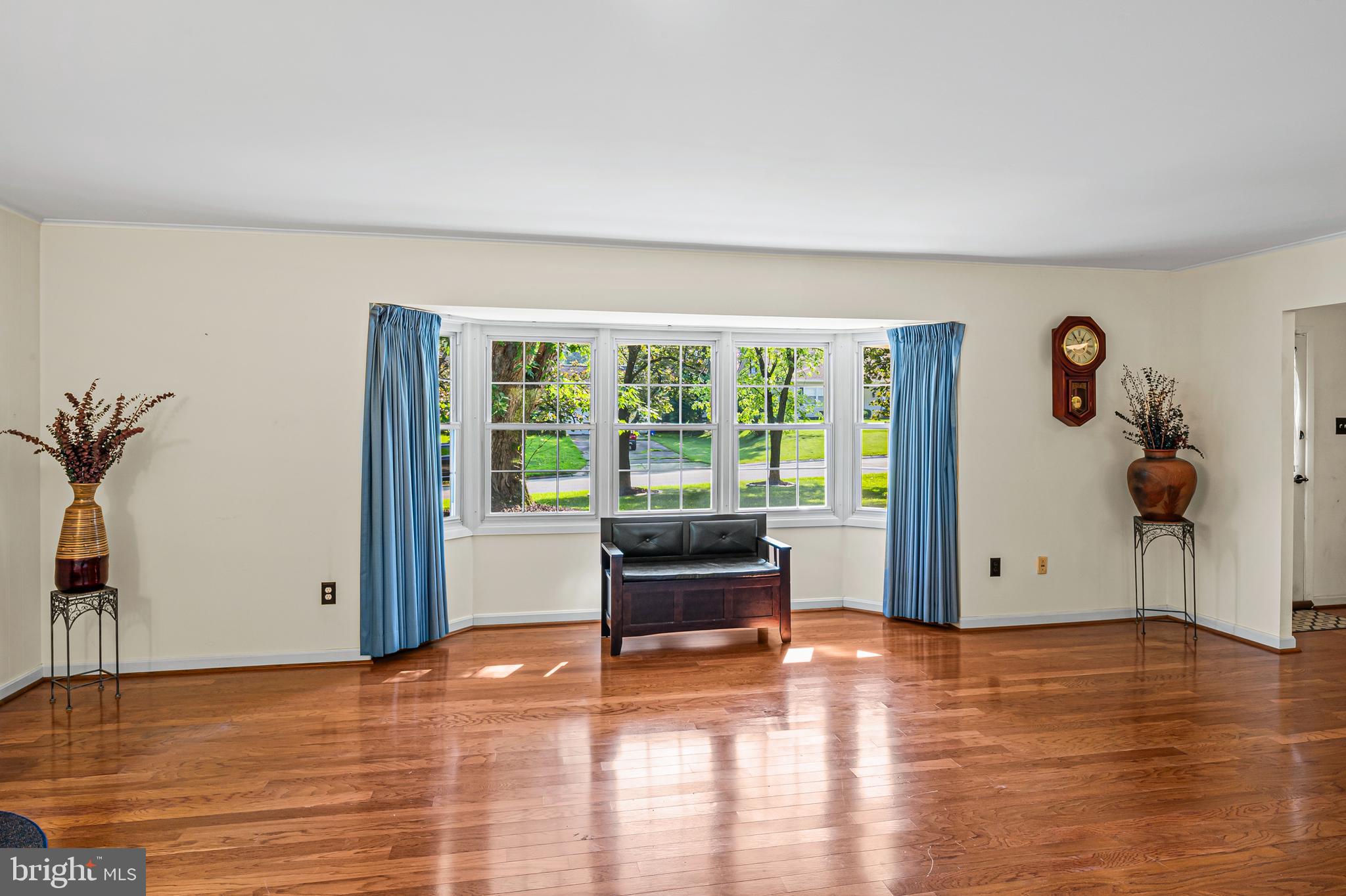 12128 Long Ridge Lane Bowie, MD 20715 - Photo 8 of 39 a view of an empty room with a window and wooden floor