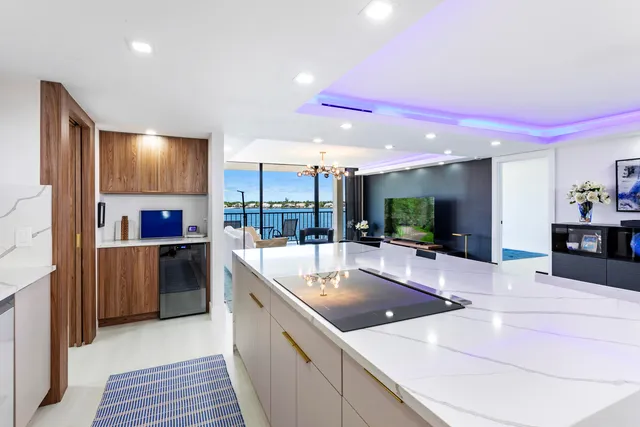 a large kitchen with a large counter top appliances and cabinets