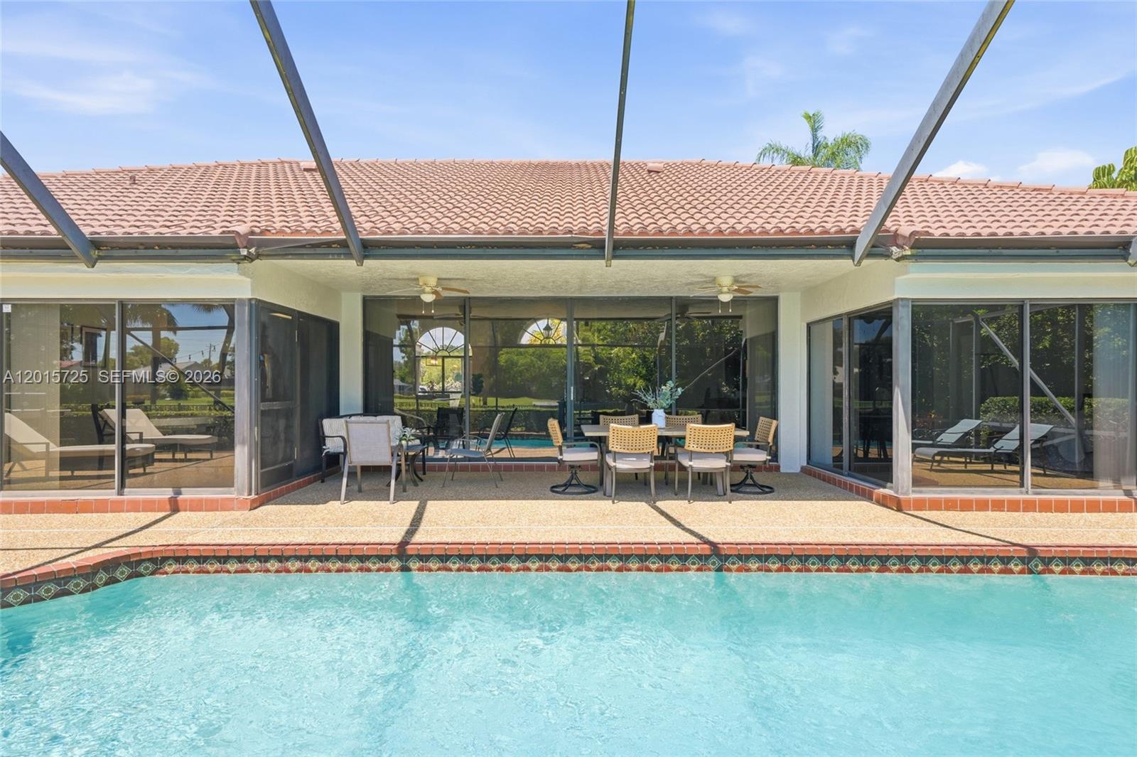 11008 Boca Woods Lane Boca Raton, FL 33428 - Photo 38 of 70 a view of a patio with a table and chairs under an umbrella